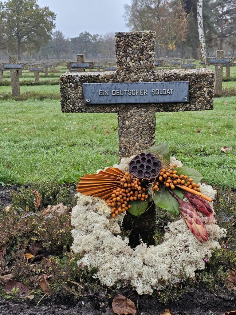 A German soldier's grave at Lommel War Cemetery with a floral wreath.